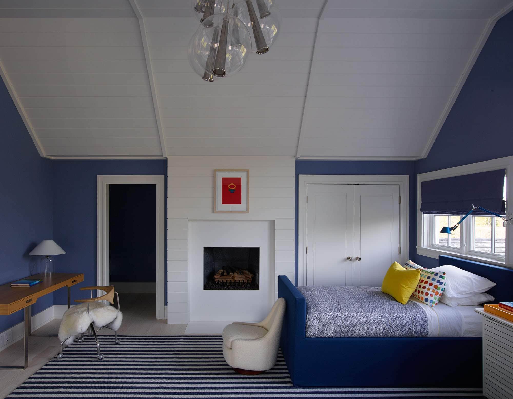 Shown here is a screened porch designed by Carol Egan with a Toro coffee table by Jacques Jarrige surrounded by a custom designed U-shaped sofa in white and contrast navy blue fabric.  The ceiling fan by Boffi and the area rug is a custom "Ray" Rug by Paola Lenti, which is designed for the outdoors.  A hanging egg chair by Nanna Ditzel has a shearling inset pillow and there is a Blue Sculpture by Sidney Geist in the corner of the room.
