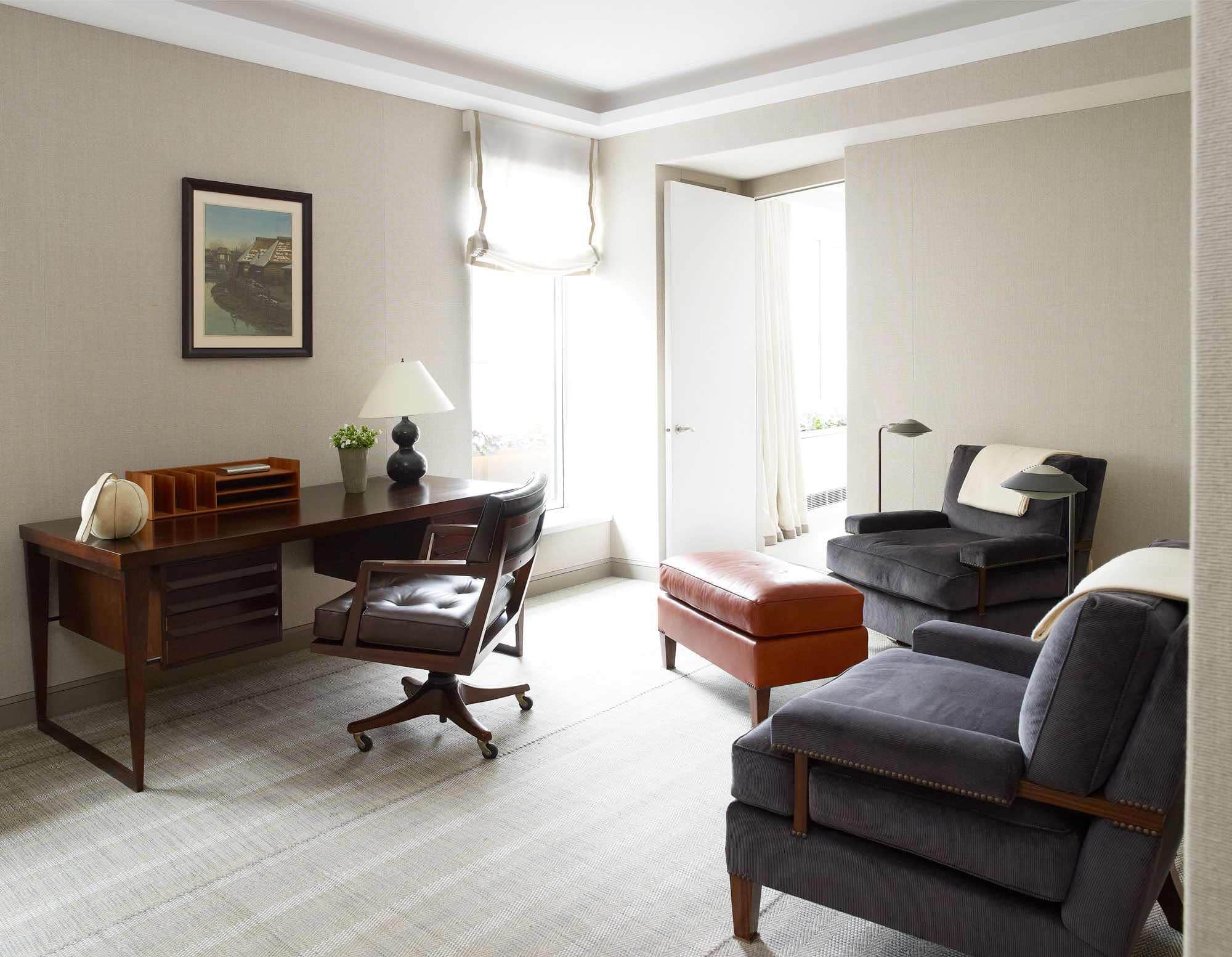This photograph shows a study filled with Danish furnishings, including a rosewood desk by Kai Kristiansen and a teak desk organizer by Pedersen and Hansen, both from the 1960s, as well as contemporary armchairs from Roman Thomas in Fustian Ash wide wale corduroy by Holland & Sherry and bronze standing lamps by Cedric Hartman on an area rug by Elizabeth Eakins.  Designed by Carol Egan the study is adjacent to the master bedroom suite in a Fifth Avenue Apartment which overlooks Central park in New York City.