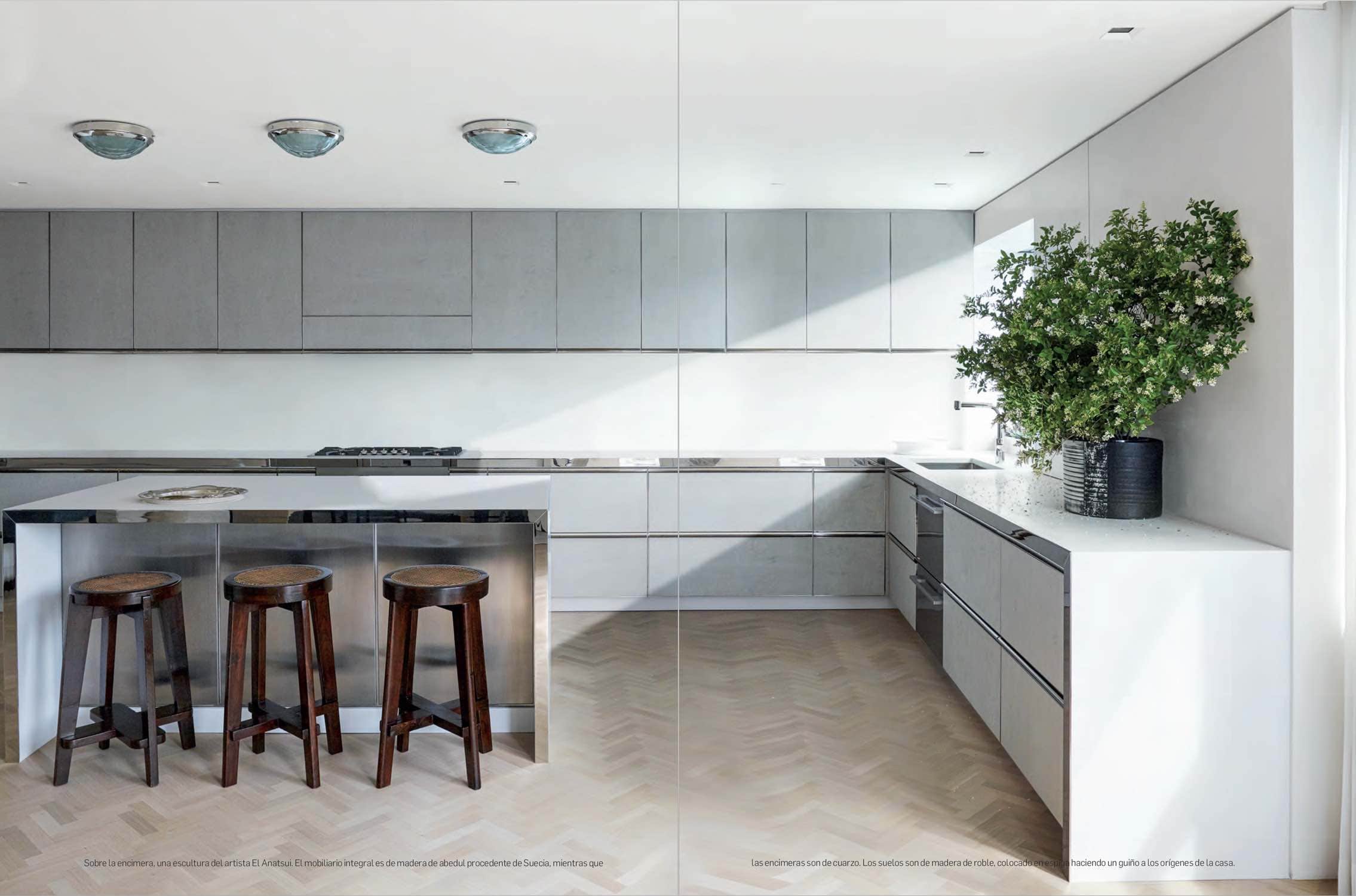 Image of a kitchen with barstools by Pierre Jeanneret and 1960s ceiling lights by Fontana Arte.  Interior design by Carol Egan.