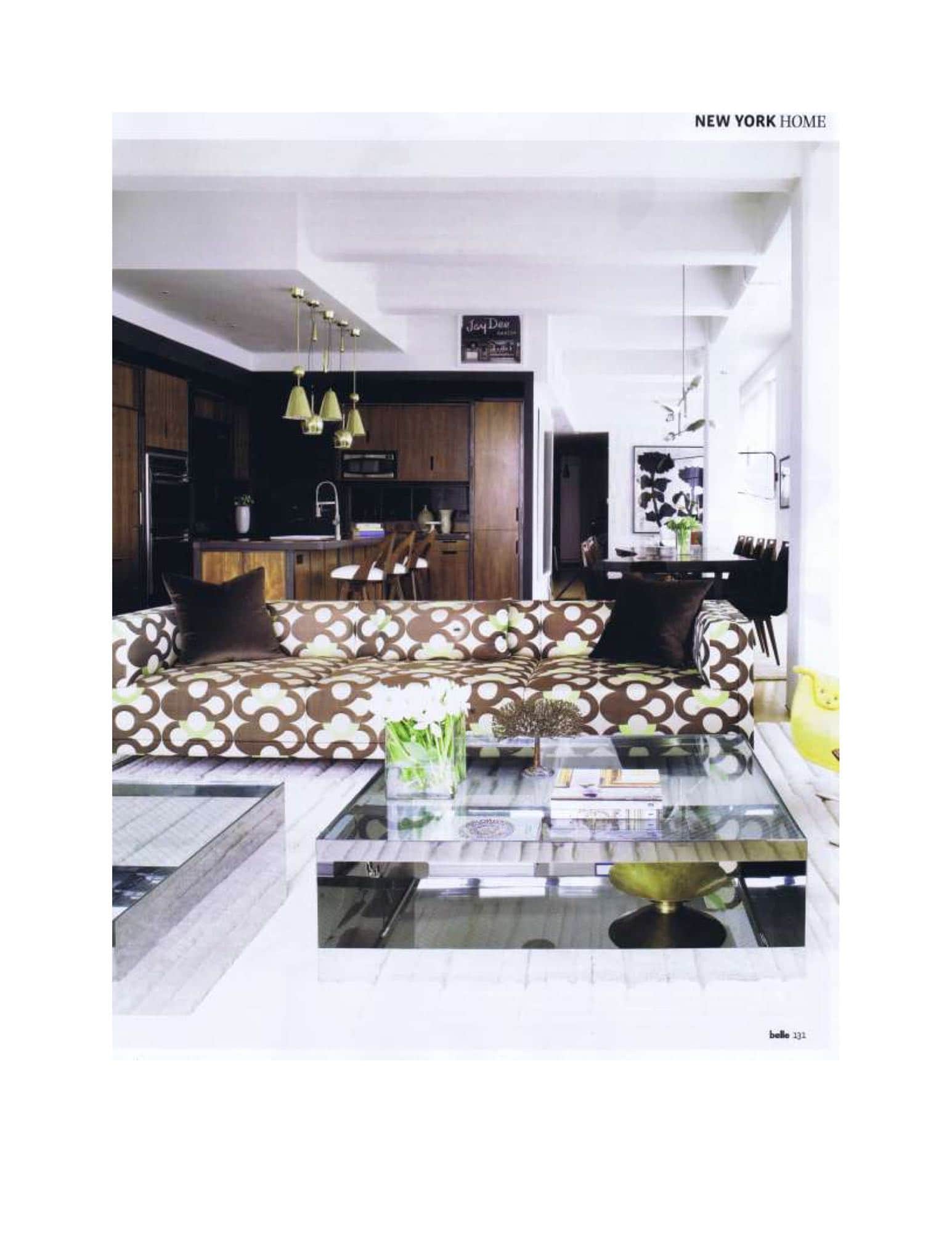 Prelle "Arabesque" fabric, designed in 1968, was a bold choice for the sofas.  The steel and glass coffee tables by Joe D urso were custom made for the space from an existing design.   Walnut kitchen units are offset by 50s brass Paavo Tynell pendant lights.  Interior design by Carol Egan.