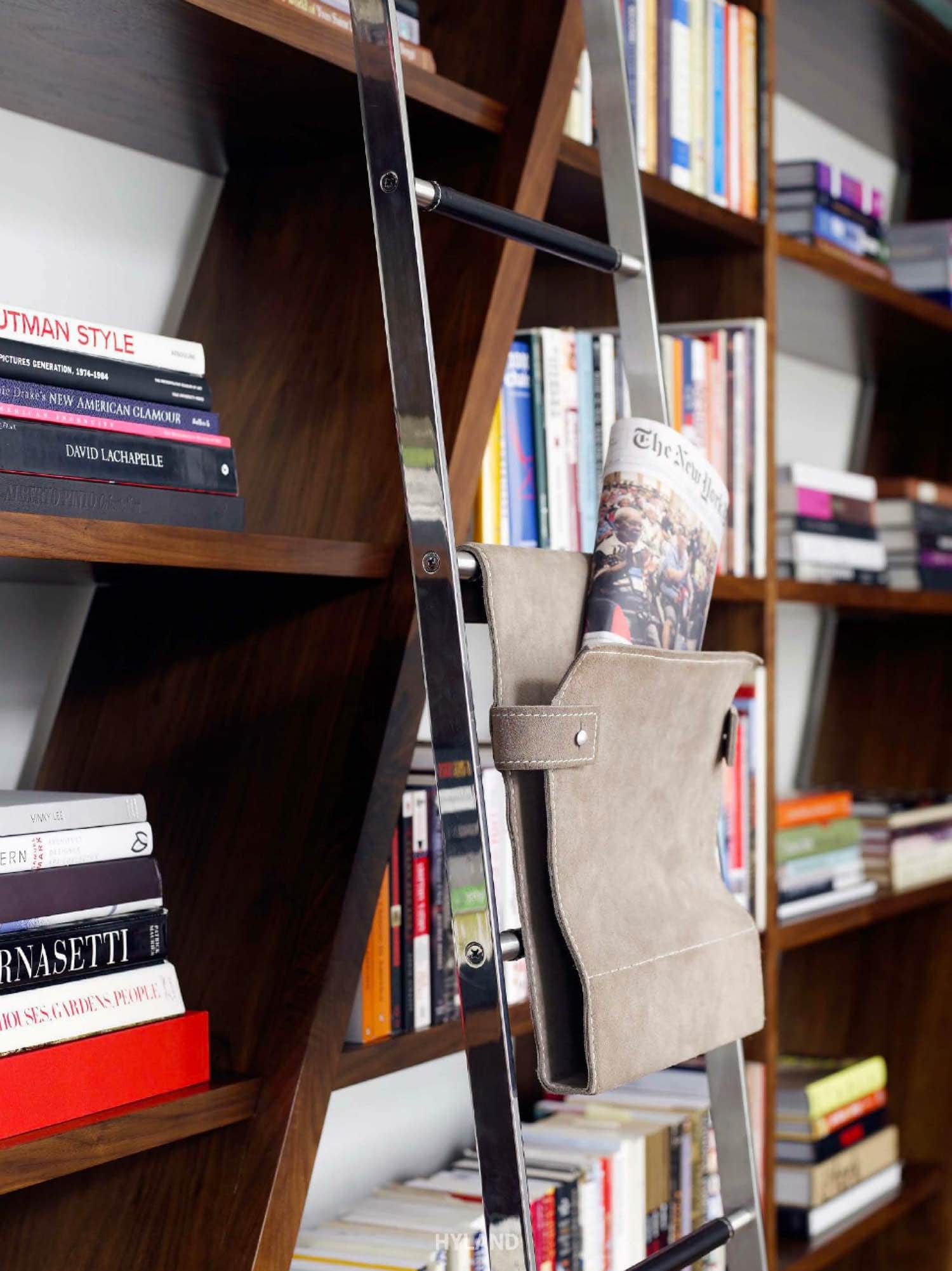 Photograph with custom rolling ladder and satchel design by Carol Egan Interiors.